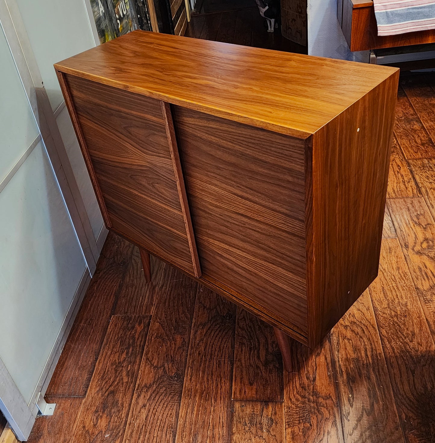 REFINISHED MCM walnut cabinet w sliding doors, narrow, fits records 37.5”