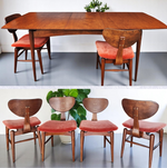 A set of mid-century modern dining furniture including a wood-finished dining table and six chairs with orange upholstered seats, displayed in two images, one showing the table with chairs arranged around it, and the other displaying the chairs alone from a front angle. 1