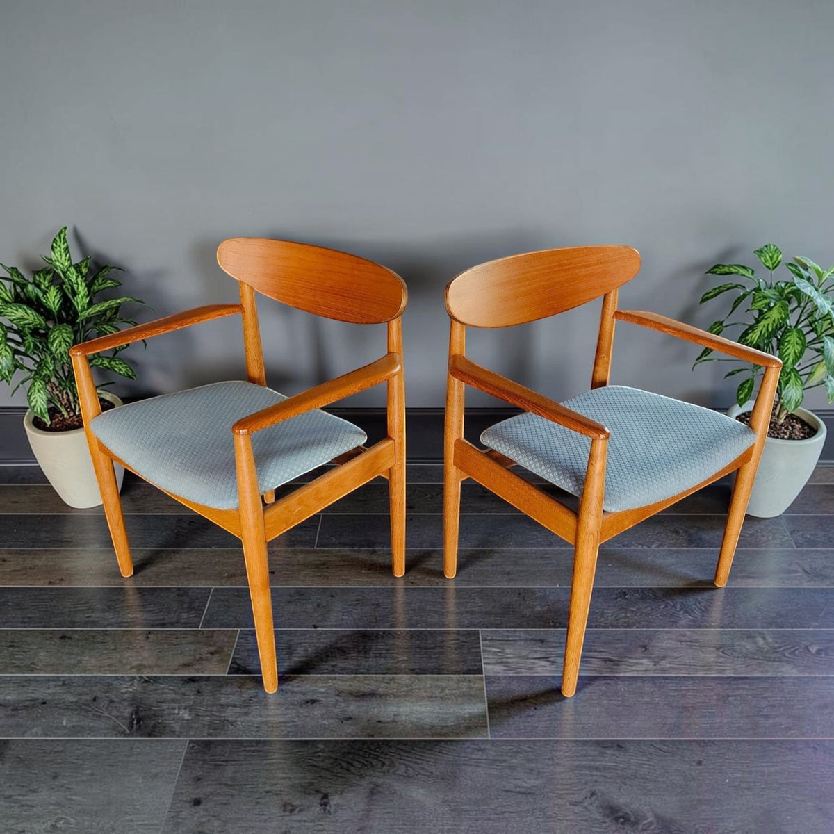 Mid Century Modern Toronto Danish teak and oak armchairs with blue upholstered seats in a minimalist dining room