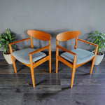 Mid Century Modern Toronto Danish teak and oak armchairs with blue upholstered seats in a minimalist dining room 8