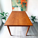 Mid Century Modern Toronto refinished Danish teak and oak extendable dining table with tapered legs in a bright room. 3