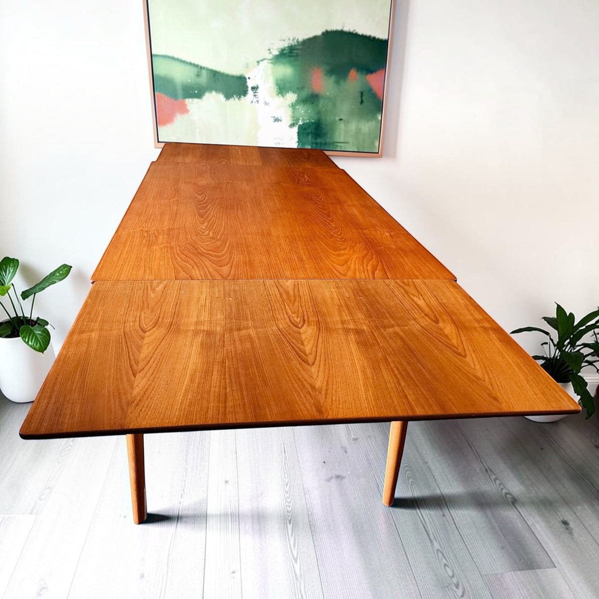 Mid Century Modern Toronto refinished teak and oak extendable dining table with visible wood grain in a bright room.