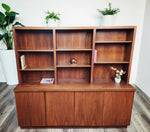 Refinished Mid Century Modern Toronto walnut cabinet with 4 doors and open shelving topper. Features adjustable shelves. 1