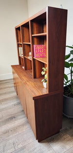 Mid Century Modern Toronto refinished walnut cabinet with shelving. Features 4 doors on the bottom and adjustable shelves on top. 2